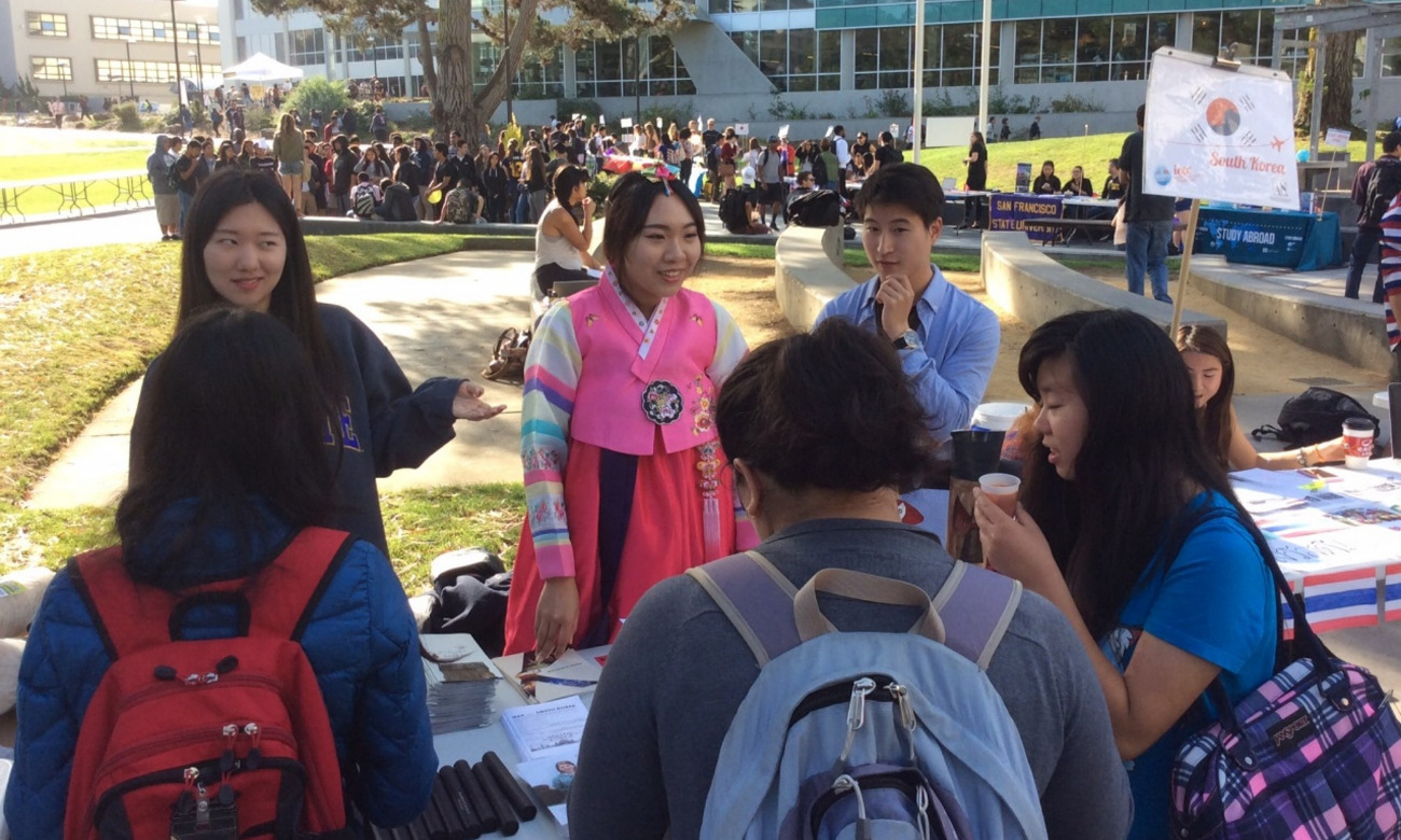 Students around a table at the fair