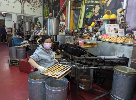 Woman sitting and making fortune cookies