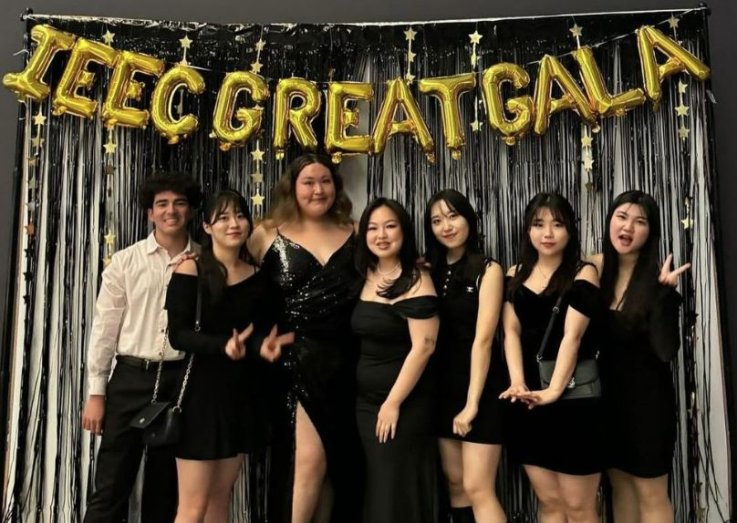 Dressed up students in front of the banner that says IEEC Gala