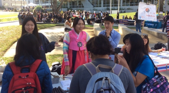 Students standing around the Korea table.